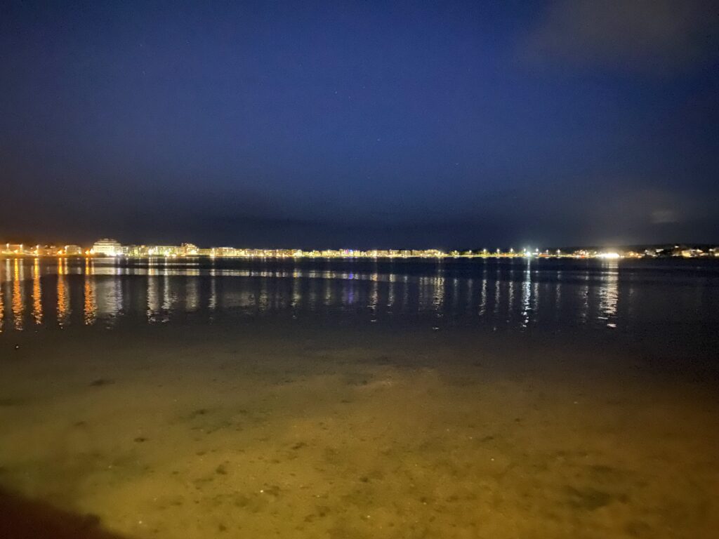 Lights reflected in the water of Poole Harbour.