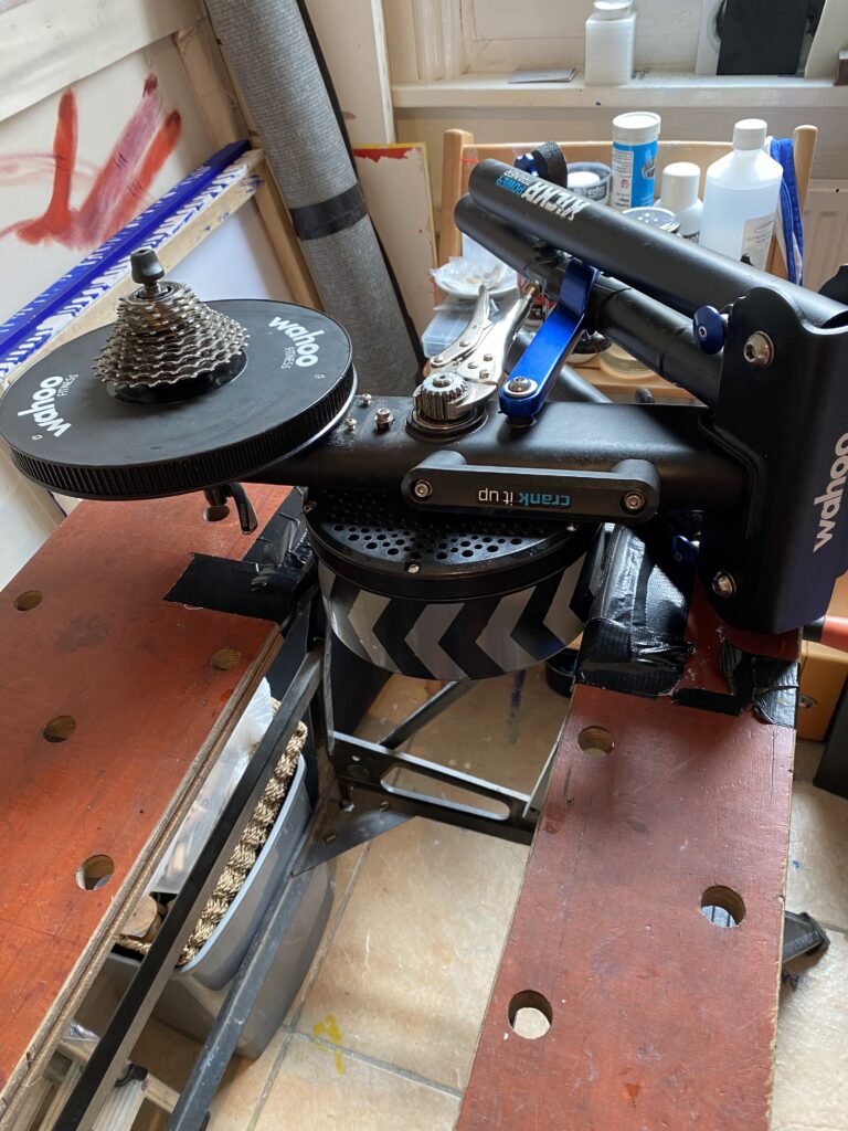 Wahoo Kickr repair:- Kickr flywheel gripped between the jaws of a workmate before torquing off the drive cog