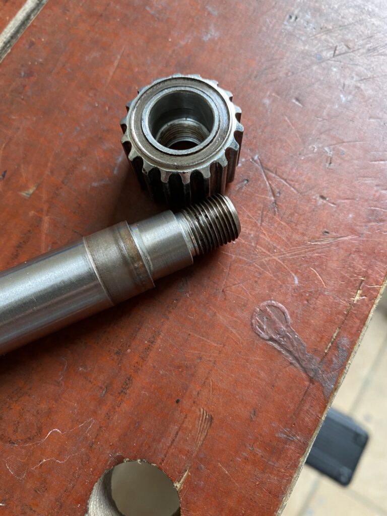 Wahoo Kickr repair:- Kickr axle with cog removed showing wear and rust on both parts