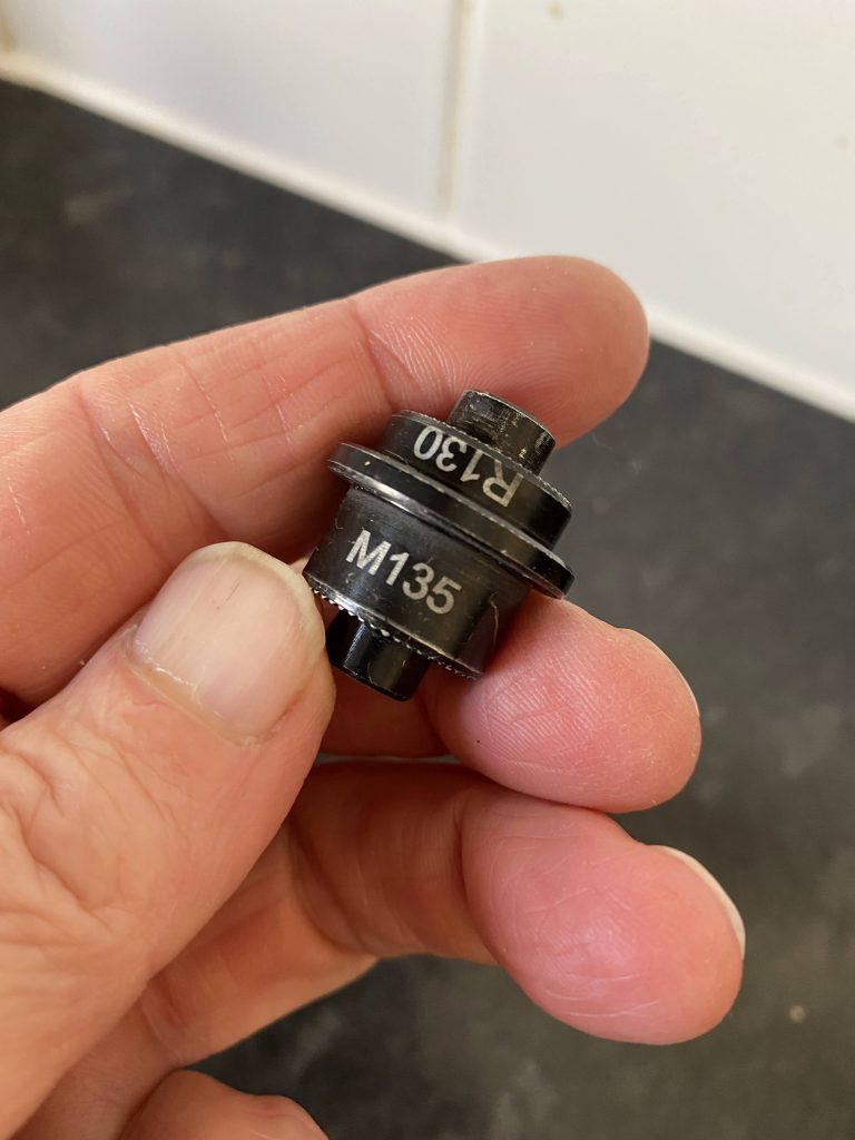 Wahoo Kickr repair:- Nubbin (quick release adapter). The R stands for 'road bike'. When that side sticks out, standard 130mm wide road bike dropouts fit. M stands for 'mountain bike' and is for 135mm mountain bike wide dropouts!