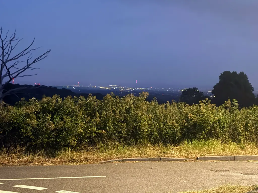 The far off lights of London Town twinkling as night begins to fall